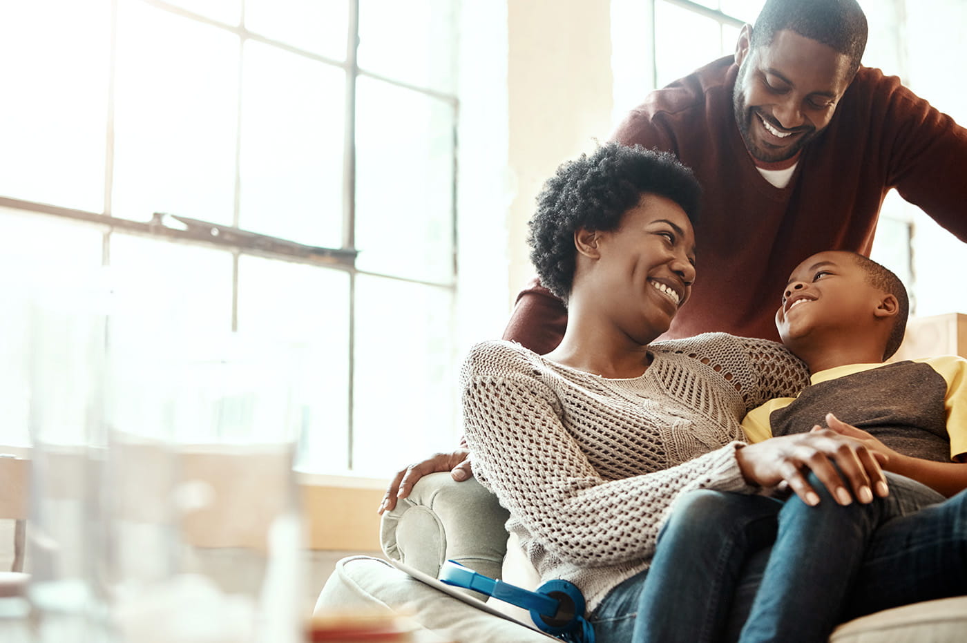 A couple at home with their young child.