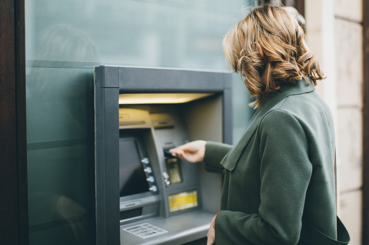 A woman using an ATM.