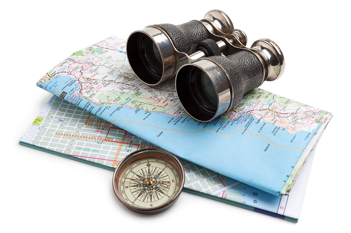 Maps, compass, and binoculars stacked together.