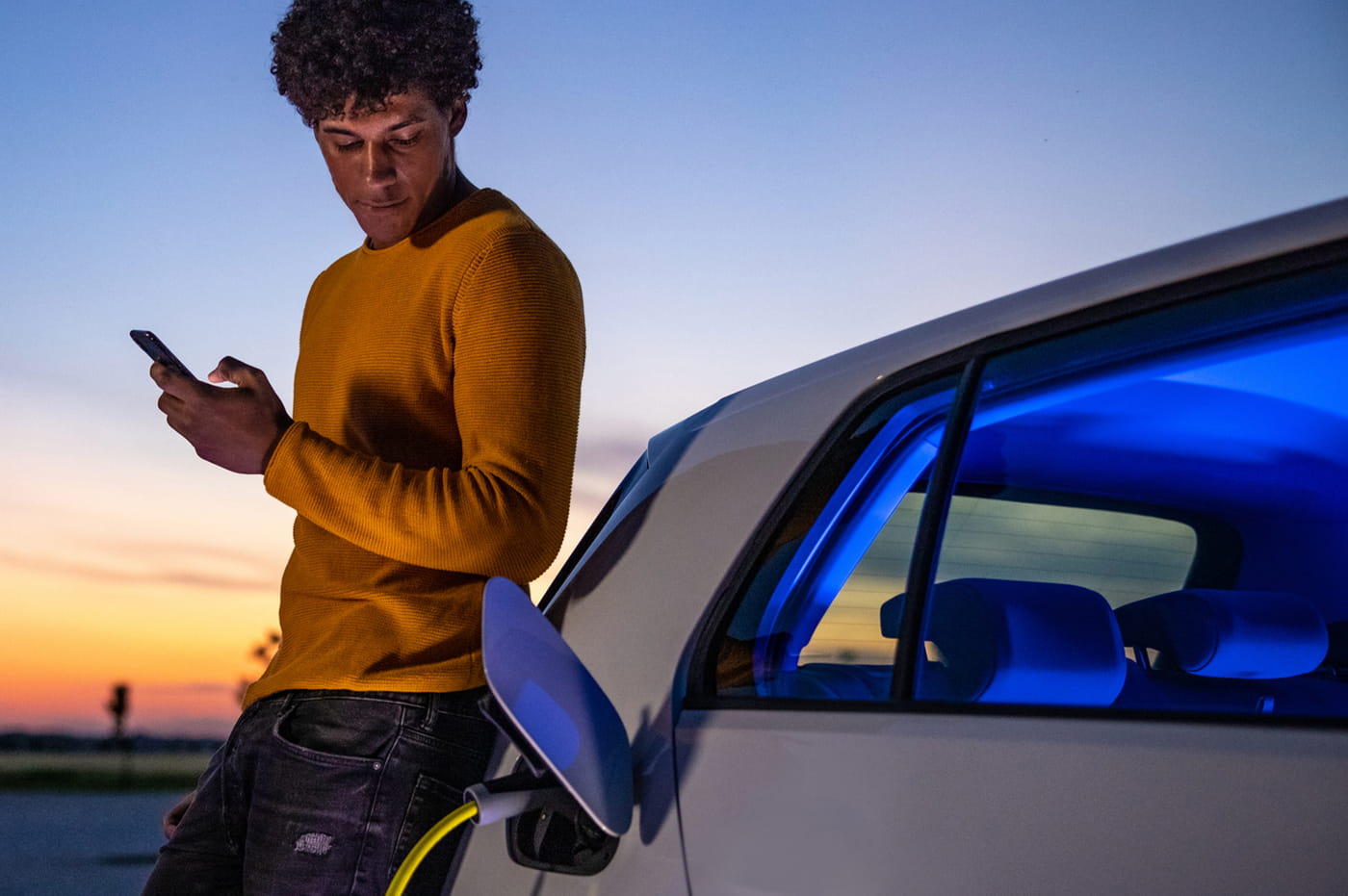 A man charging his electric vehicle.